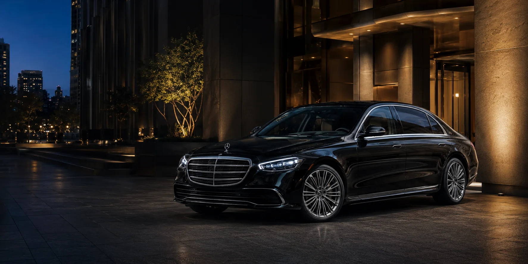 Representative black Mercedes S-Class outside a downtown Los Angeles office entrance at night